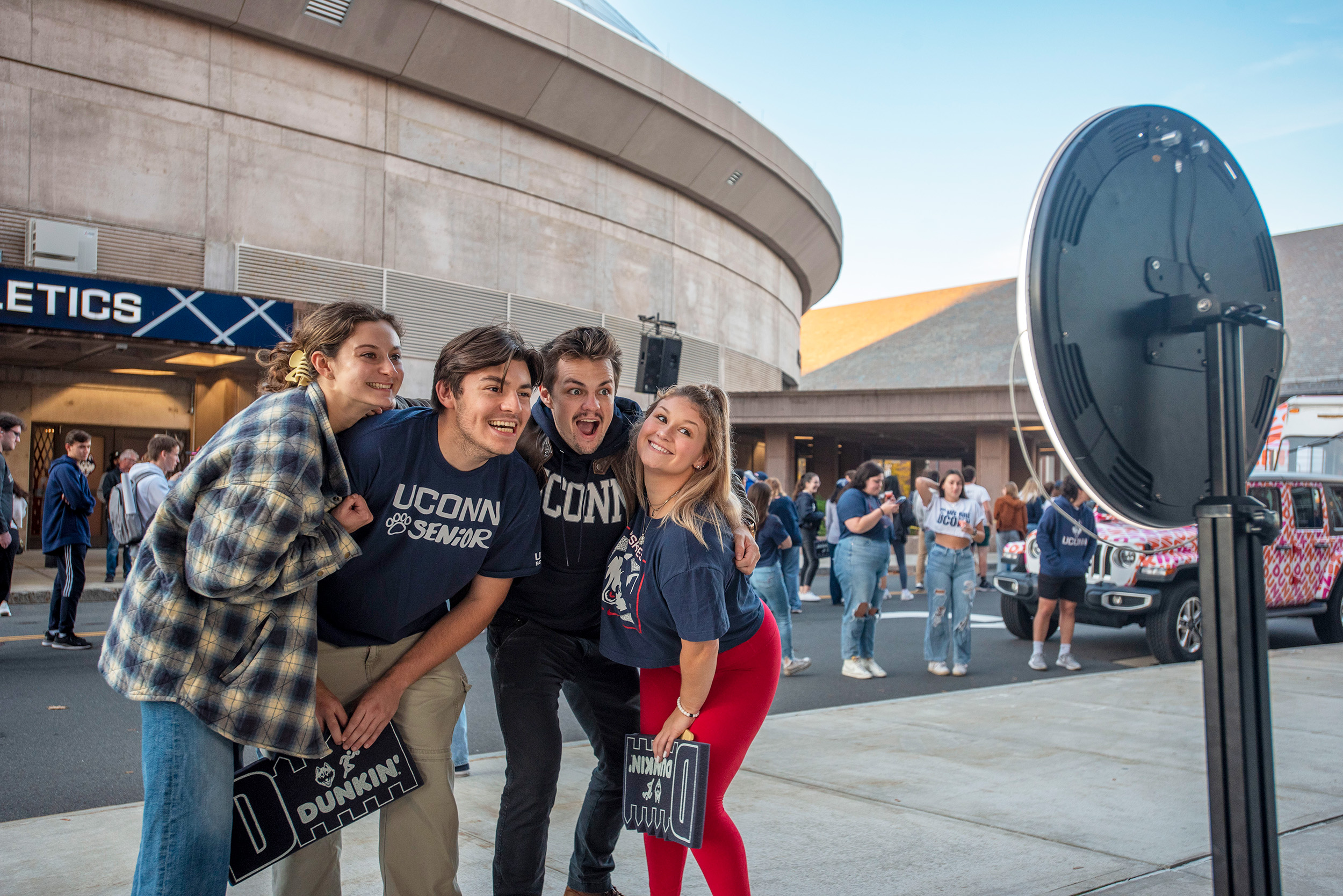 Group of Students having their picture taken by a 3D camera while gathered outside of Gampel Pavilion before First Night.